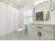 Bright bathroom featuring a white vanity with modern fixtures, a toilet and shower with a white shower curtain at 601 Cherokee Rd, Charlotte, NC 28207