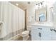 Well-lit bathroom features white cabinets, a modern mirror, and a shower with a curtain at 601 Cherokee Rd, Charlotte, NC 28207