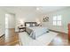 Bedroom with hardwood floors, a queen-sized bed, decorative pillows and a nightstand on each side at 601 Cherokee Rd, Charlotte, NC 28207