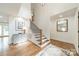 Bright foyer with hardwood floors, staircase with black iron railings, and soaring ceilings at 601 Cherokee Rd, Charlotte, NC 28207