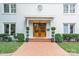 Charming front entrance with a brick walkway, manicured bushes, and beautiful wooden doors at 601 Cherokee Rd, Charlotte, NC 28207