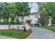 Exterior of a white home with a well-manicured front yard, walkway, and mature trees at 601 Cherokee Rd, Charlotte, NC 28207