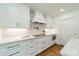 Sleek kitchen featuring marble countertops and backsplash and ample storage space at 601 Cherokee Rd, Charlotte, NC 28207