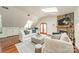 Bright living room features a stone fireplace, hardwood floors, skylight and comfortable seating at 601 Cherokee Rd, Charlotte, NC 28207