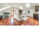 Spacious living room with hardwood floors, a stone fireplace, and plenty of natural light from skylights at 601 Cherokee Rd, Charlotte, NC 28207