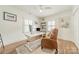 Comfortable home office with a modern desk, leather chair, and natural light, ideal for remote work at 601 Cherokee Rd, Charlotte, NC 28207