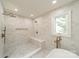 Modern shower with dual shower heads, a built-in bench, and elegant tile work at 601 Cherokee Rd, Charlotte, NC 28207