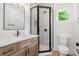 Stylish bathroom featuring a glass shower, toilet, wood vanity, and mirror at 605 Poplar St, Shelby, NC 28150