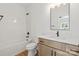 Bright bathroom with a tub-shower, wood vanity, modern sink and lighting at 605 Poplar St, Shelby, NC 28150
