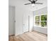 Cozy bedroom with a ceiling fan, natural light, and wood-look floors at 605 Poplar St, Shelby, NC 28150