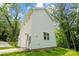 Modern white siding and ample windows highlight this charming two-story home nestled among mature trees at 605 Poplar St, Shelby, NC 28150