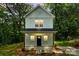 Charming two-story home with white siding, a covered porch, and simple landscaping at 605 Poplar St, Shelby, NC 28150