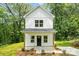 Charming two-story home with white siding, a covered porch, and simple landscaping at 605 Poplar St, Shelby, NC 28150