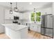 Modern kitchen with white cabinets, stainless steel appliances, and quartz countertops at 605 Poplar St, Shelby, NC 28150