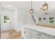 Modern kitchen with white cabinets, stainless steel appliances, island, and hardwood floors at 605 Poplar St, Shelby, NC 28150