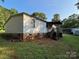 Backyard with siding, stone foundation and a wooden porch with stairs at 6544 Helens Way, Denver, NC 28037
