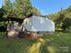 Backyard with siding, stone foundation and a wooden porch with stairs at 6544 Helens Way, Denver, NC 28037