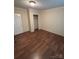 Bright bedroom with durable wood-look flooring and an essential closet for storage at 6544 Helens Way, Denver, NC 28037