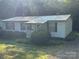 Quaint home with a charming porch, manicured landscaping, and a metal roof at 6544 Helens Way, Denver, NC 28037