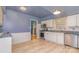 Cozy kitchen with stainless steel appliances, white cabinets, and wood-look flooring at 6577 Stoney Ridge Rd, Matthews, NC 28104