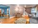 Open-concept living room with hardwood floors, neutral walls, connecting to other rooms, with classic furnishings at 6577 Stoney Ridge Rd, Matthews, NC 28104