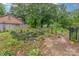 Backyard pond surrounded by lush foliage at 6577 Stoney Ridge Rd, Matthews, NC 28104