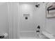 Bright bathroom featuring a tiled shower with niche and modern fixtures at 7219 Brynhurst Dr, Charlotte, NC 28210
