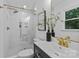 Modern bathroom featuring a stylish vanity, shower with glass door, and decorative accents at 7219 Brynhurst Dr, Charlotte, NC 28210