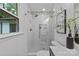 Bright bathroom with a glass-enclosed shower, white tile, and modern fixtures at 7219 Brynhurst Dr, Charlotte, NC 28210