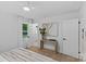 Bright bedroom featuring two closets, light colored walls, and door to the outside at 7219 Brynhurst Dr, Charlotte, NC 28210