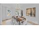Bright and airy dining room with modern chandelier, light-colored walls, and view to the entry door at 7219 Brynhurst Dr, Charlotte, NC 28210