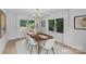 Bright dining room with modern chandelier, light-colored walls, and window views at 7219 Brynhurst Dr, Charlotte, NC 28210