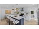 The kitchen showcases an island with seating, modern fixtures, and seamless flow into the dining area at 7219 Brynhurst Dr, Charlotte, NC 28210