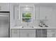 Bright kitchen with stainless steel appliances, white cabinetry, and a view from the window at 7219 Brynhurst Dr, Charlotte, NC 28210