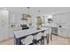 Bright kitchen features an island with breakfast bar, stainless appliances, and modern finishes at 7219 Brynhurst Dr, Charlotte, NC 28210