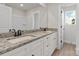 Modern bathroom featuring a double vanity with granite countertop and matte black fixtures at 7225 Jerimoth Dr, Charlotte, NC 28215