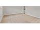 Bedroom with beige carpet and white walls with bathroom access at 7225 Jerimoth Dr, Charlotte, NC 28215