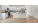 Kitchen with stainless steel appliances, granite countertops, white cabinets and light wood floors at 7225 Jerimoth Dr, Charlotte, NC 28215