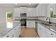 A kitchen with stainless steel appliances, a central island, white cabinets, and granite countertops at 7225 Jerimoth Dr, Charlotte, NC 28215