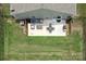 Aerial view of a backyard featuring a patio, outdoor seating, and a green lawn with a privacy fence at 7328 Strawberry Fields Ln, Charlotte, NC 28278