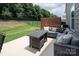 Well-appointed outdoor patio with comfortable seating, a privacy screen, and a view of the fenced yard at 7328 Strawberry Fields Ln, Charlotte, NC 28278