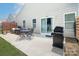 Spacious backyard patio with a dining table, seating area, and grill, ideal for outdoor entertaining at 7328 Strawberry Fields Ln, Charlotte, NC 28278