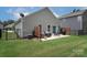 Spacious backyard with a patio, seating, and well-maintained lawn, perfect for outdoor activities at 7328 Strawberry Fields Ln, Charlotte, NC 28278