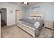 Calm bedroom featuring soft blue walls, a queen bed, and neutral décor, creating a serene retreat at 7328 Strawberry Fields Ln, Charlotte, NC 28278