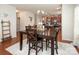 Dining area with wood table and seating for four, connecting the kitchen and living spaces at 7328 Strawberry Fields Ln, Charlotte, NC 28278