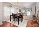 Dining room area features a table with seating for four, natural light, and an open floor plan at 7328 Strawberry Fields Ln, Charlotte, NC 28278