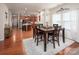 Dining area next to kitchen featuring a table with seating for four and hardwood floors at 7328 Strawberry Fields Ln, Charlotte, NC 28278