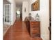 Inviting entryway featuring hardwood floors and a decorative wooden console table at 7328 Strawberry Fields Ln, Charlotte, NC 28278