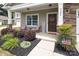 Inviting front porch with a Welcome sign, chairs, and decorative landscaping at 7328 Strawberry Fields Ln, Charlotte, NC 28278