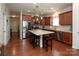 A kitchen featuring an island with seating, stainless steel appliances, and hardwood floors at 7328 Strawberry Fields Ln, Charlotte, NC 28278